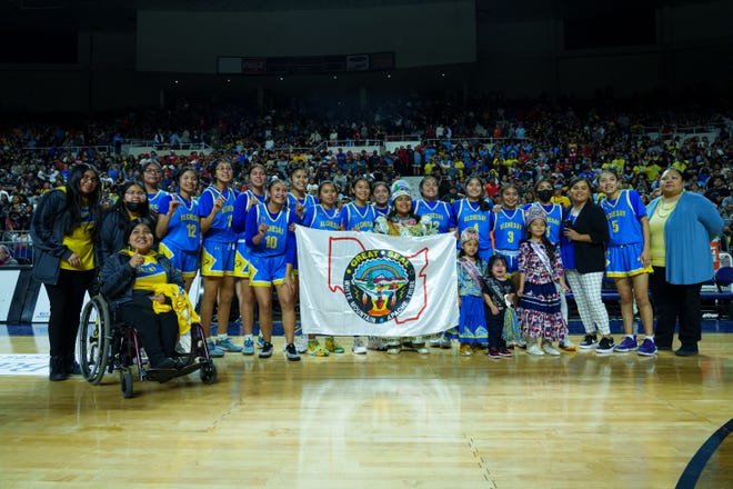 Alchesay High School girls basketball poses for a photo after they win the 2a state final at the Arizona Veterans Memorial Coliseum on Feb. 25, 2023 in Phoenix, AZ.