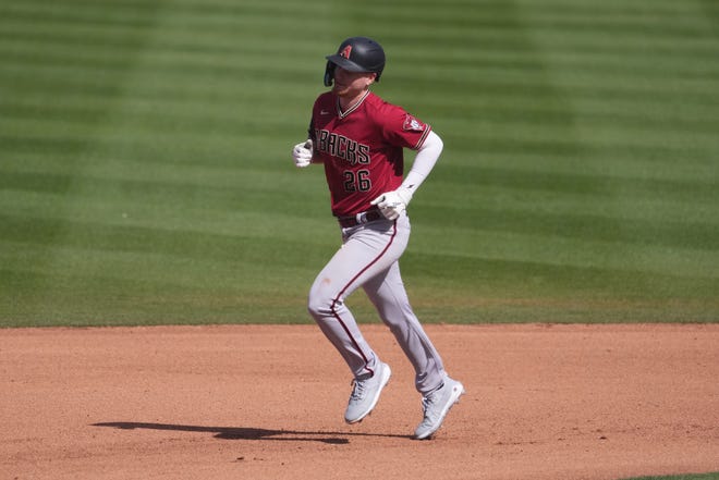 Arizona Diamondbacks right fielder Pavin Smith (26) runs the bases after hitting a two-run home run against the San Diego Padres during the third inning at Peoria Sports Complex, Feb. 26, 2023.