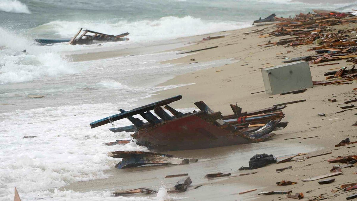 The wreckage from a capsized boat washes ashore at a beach near Cutro, southern Italy, Sunday, Feb. 26, 2023.