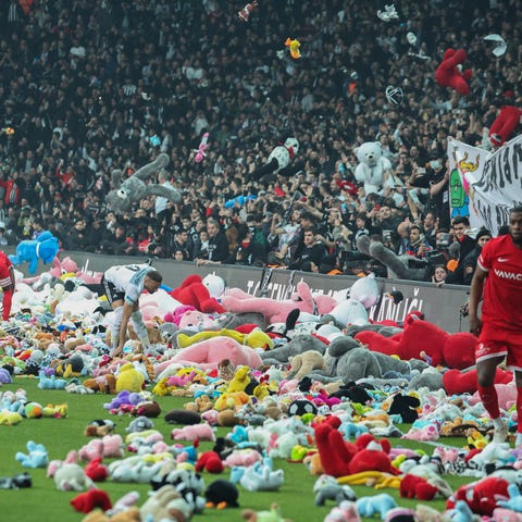 Fans throw toys onto the pitch during the Turkish 