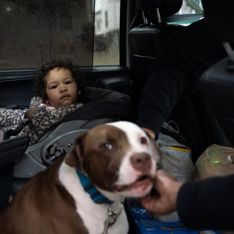 Shantel Kelly, 1, sits in her car seat near the fa