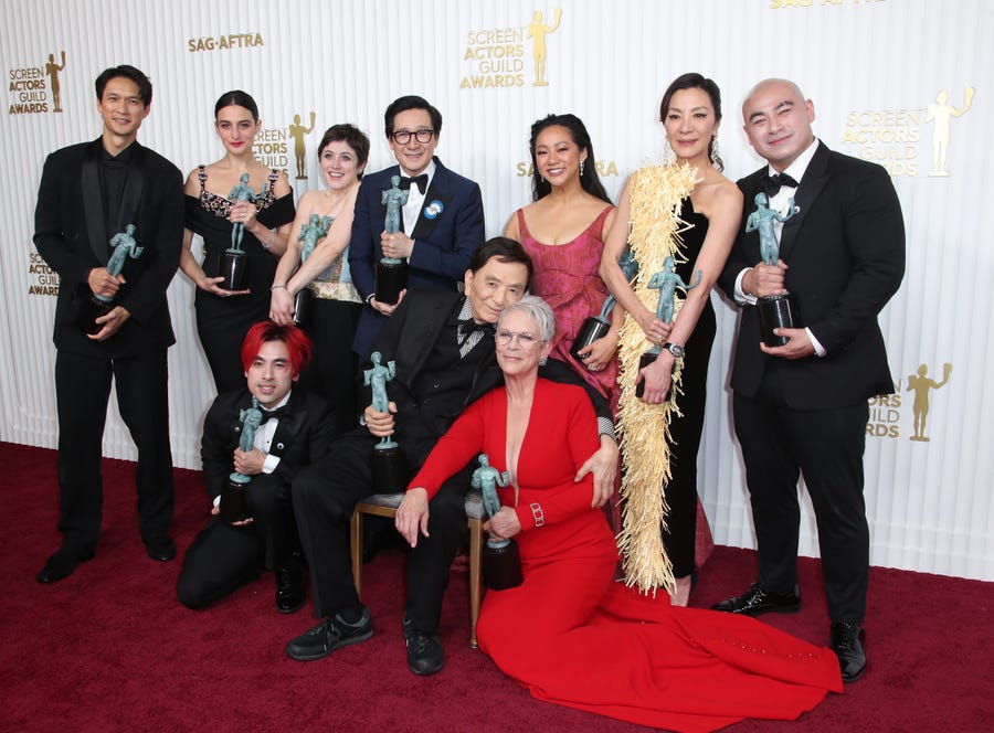 (L-R) Harry Shum Jr., Jenny Slate, Andy Le, Tallie Medel, Ke Huy Quan, James Hong, Stephanie Hsu, Jamie Lee Curtis, Michelle Yeoh and Brian Le, recipients of the Outstanding Performance by a Cast in a Motion Picture award for "Everything Everywhere All at Once ".