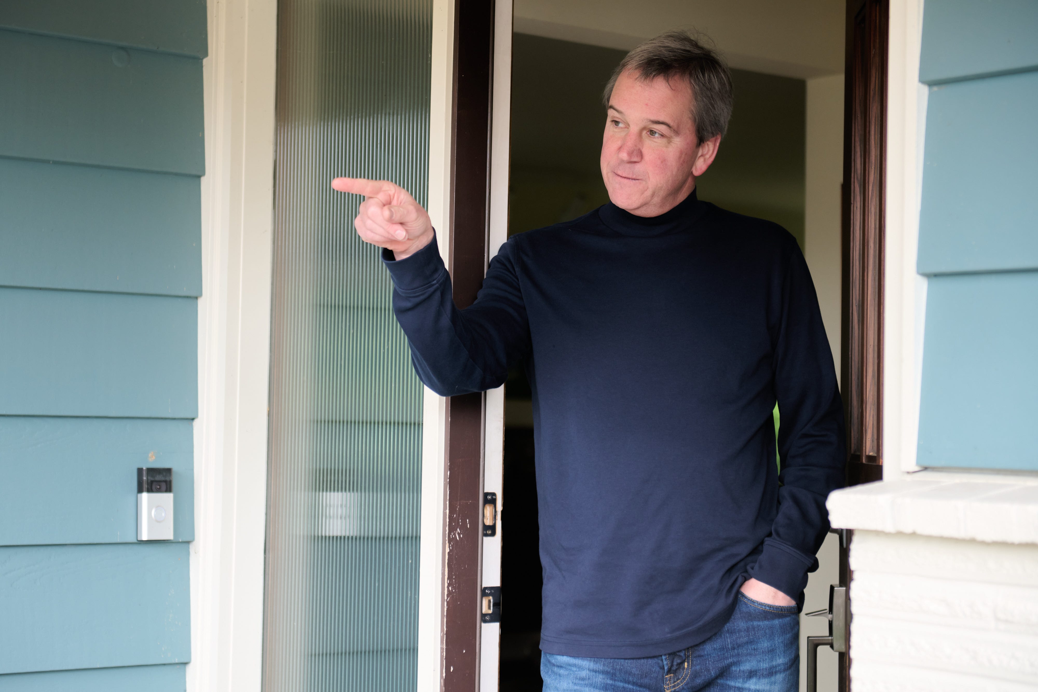 David Walsh pointing out the sewage drain outside his home in Shoreline, Washington. He and his family spent two months living out of hotels and Airbnbs while the city of Shoreline conducted numerous air tests and hired professional cleaners to try to eliminate the odor.