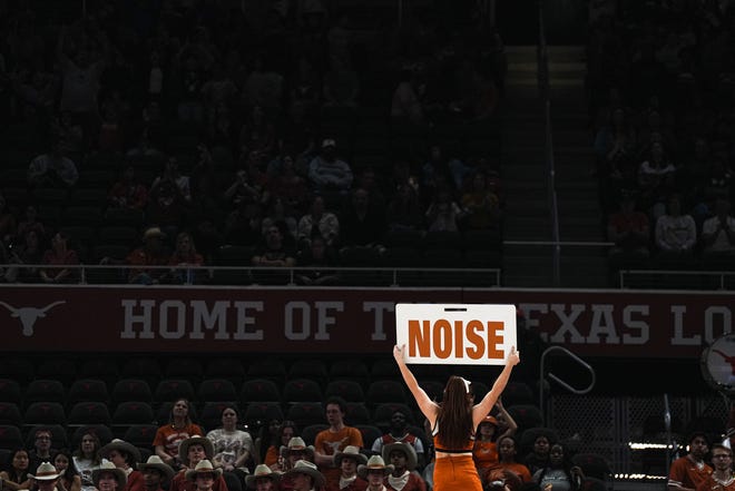 A Texas cheerleader holds up a sign trying to hype up the Moody Center crowd Monday night, but the No. 12 Longhorns still fell to Baylor 63-54 in disappointing fashion. The Longhorns were trying to claim at least a share of the Big 12 regular-season championship with a win.