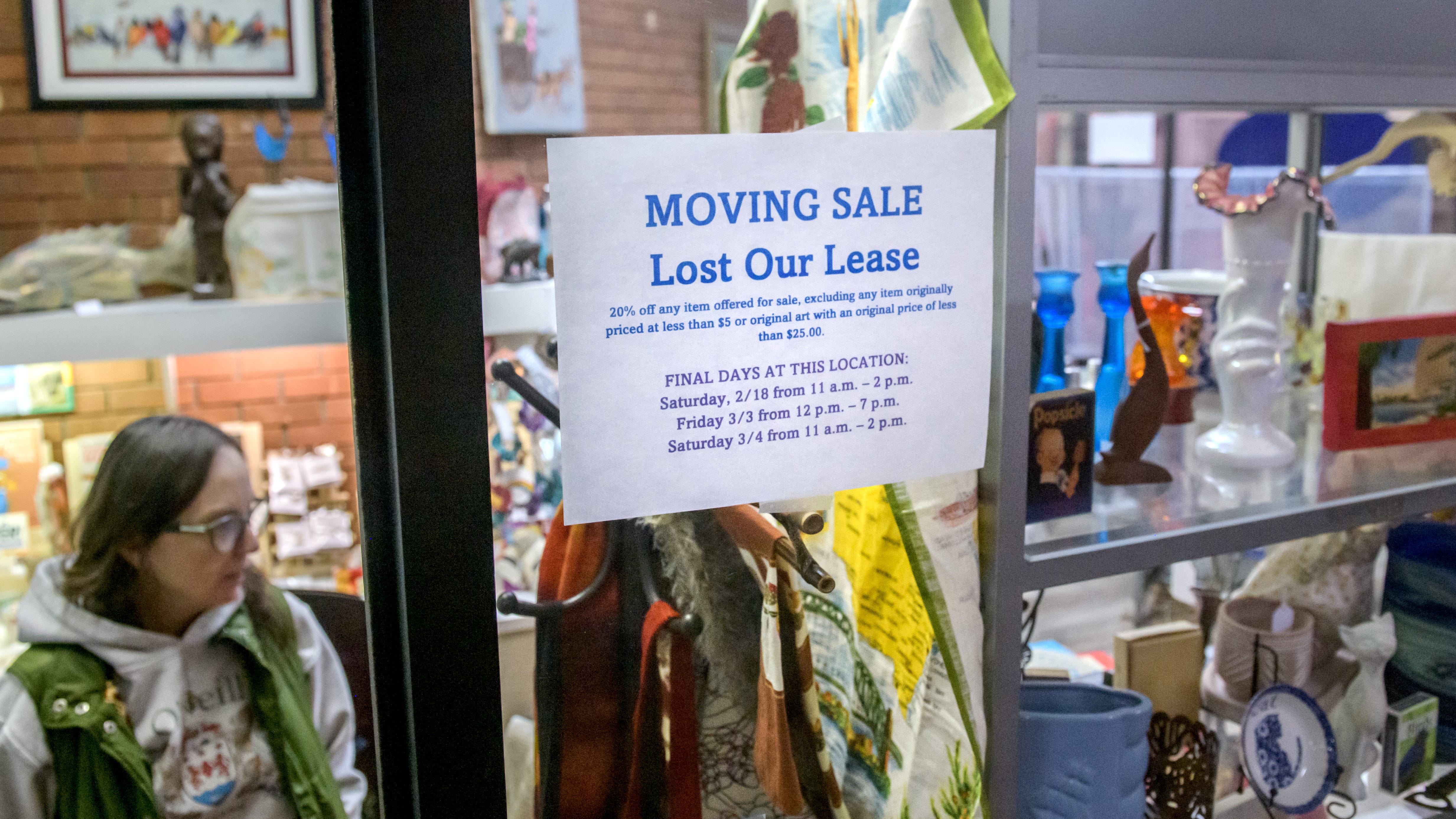 A sign on the front window of Susan O'Neal's small gift shop Origin Repurposed details the specifics of her moving out sale at the Twins Towers Mall in downtown Peoria. O'Neal was on a month-to-month lease that was not renewed by the owner of the facility.