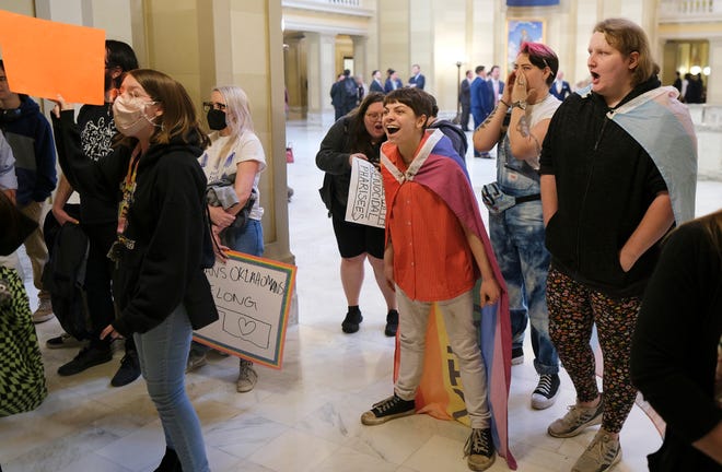 Protesters react to a speaker's comments Tuesday during a Trans Oklahomans protest outside of the House chambers during debate on a bill to limit gender transition procedures.