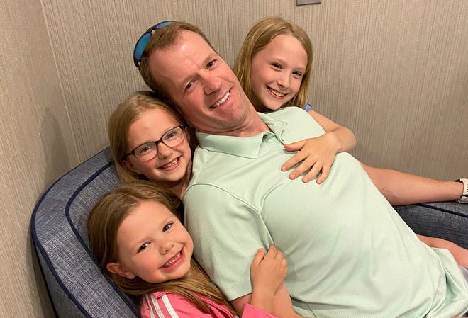 In this undated photo provided by Michael Walton, his brother Scott Walton poses with his daughters. Scott Walton, 46, was among five killed when the medical flight he was piloting crashed in rural northern Nevada on Friday, Feb. 24, 2023. There were no survivors.