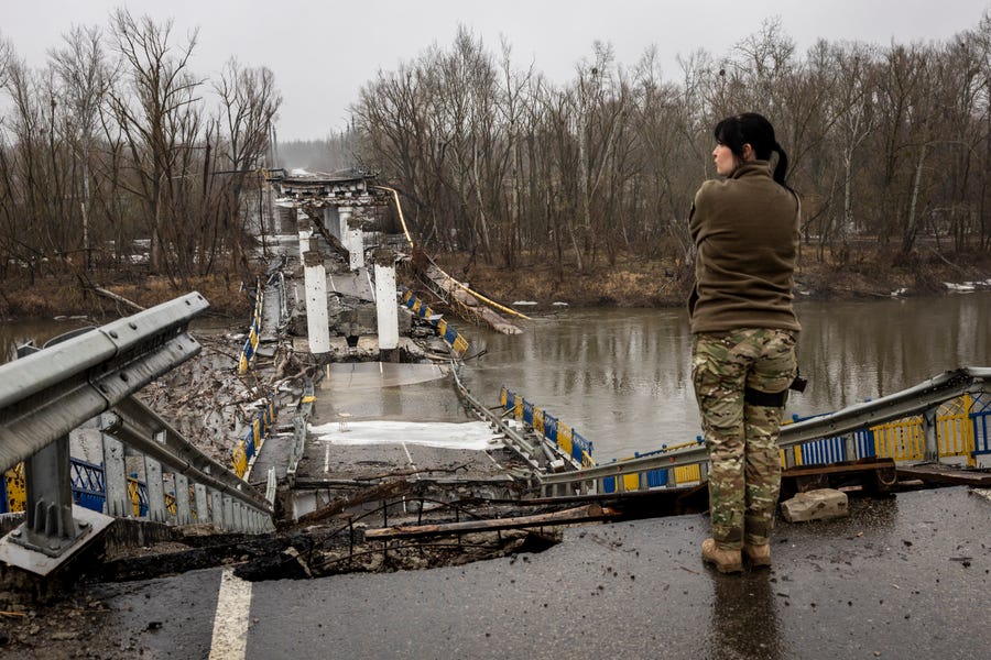 A Ukrainian Army soldier surveys a blown bridge in the Siverskiy-Donets river on February 27, 2023 in Bogorodychne, Ukraine. Last February, Russia's military invaded Ukraine from three sides and launched airstrikes across the country. Since then, Moscow has withdrawn from north and central parts of Ukraine, focusing its assault on the eastern Donbas region, where it had supported a separatist movement since 2014. 