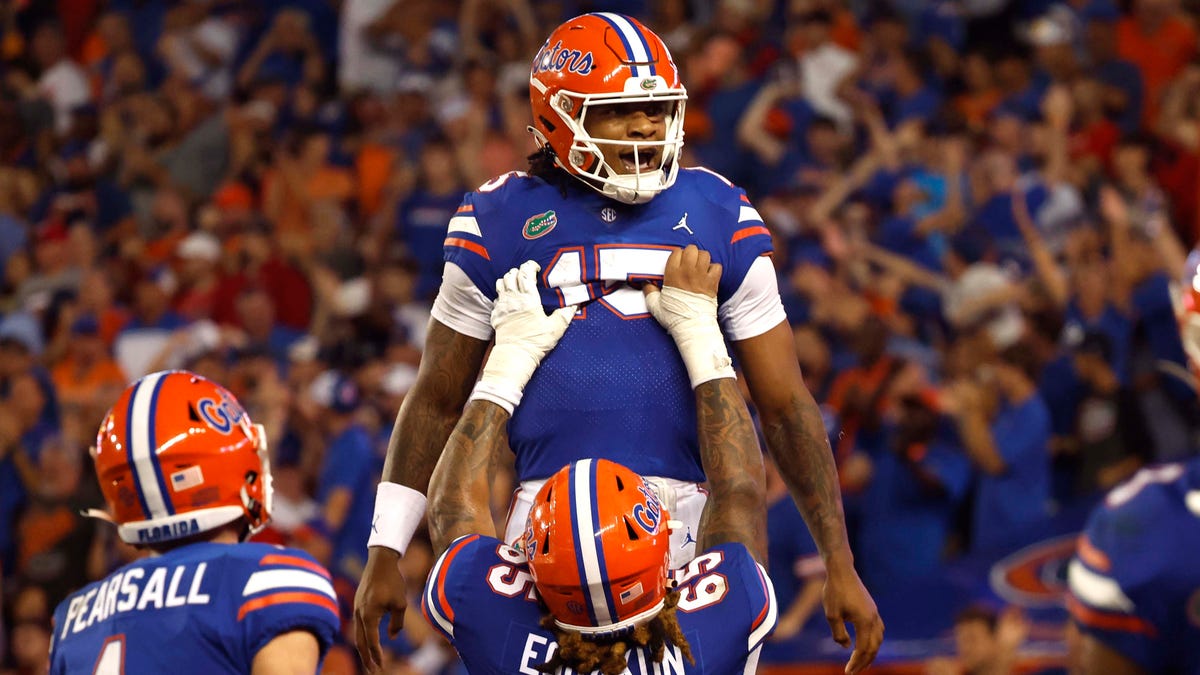 Florida Gators quarterback Anthony Richardson (15) is congratulated  by  offensive lineman Kingsley Eguakun (65) after he scored a touchdown against the Utah Utes during the second quarter at Steve Spurrier-Florida Field.