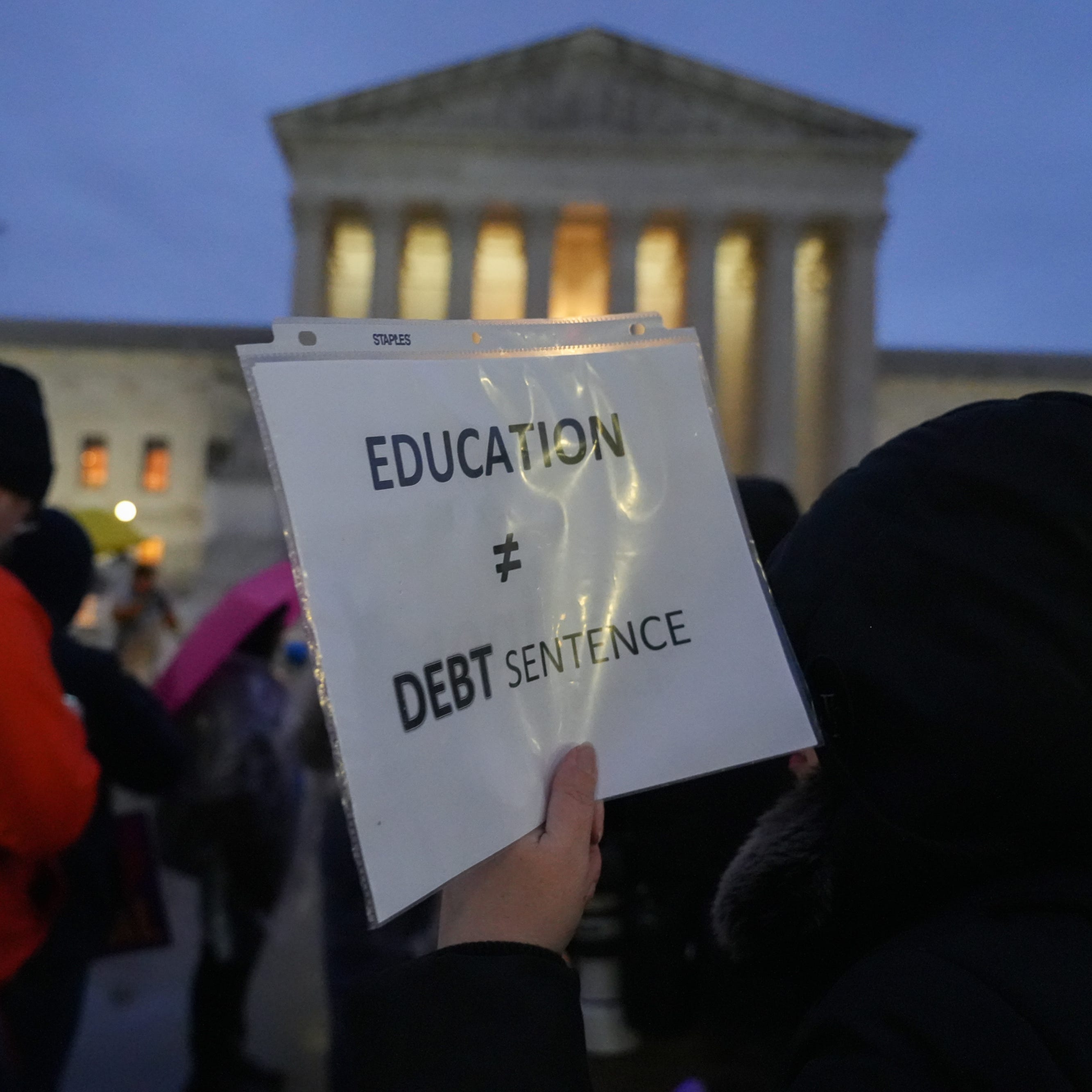 Protestors gather outside the U.S. Supreme Court on Feb. 27, 2023 in Washington, D.C., ahead of the oral arguments in two cases that challenge President Joe Biden's $400 billion student loan forgiveness plan.