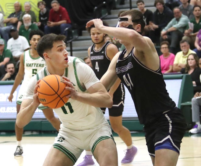 Stetson University's Josh Smith #11 looks for a shot under pressure from Lipscomb's Jacob Ognacevic #41, Tuesday February 28, 2023 during ASUN quarterfinal game at the Edmond's Center in DeLand.