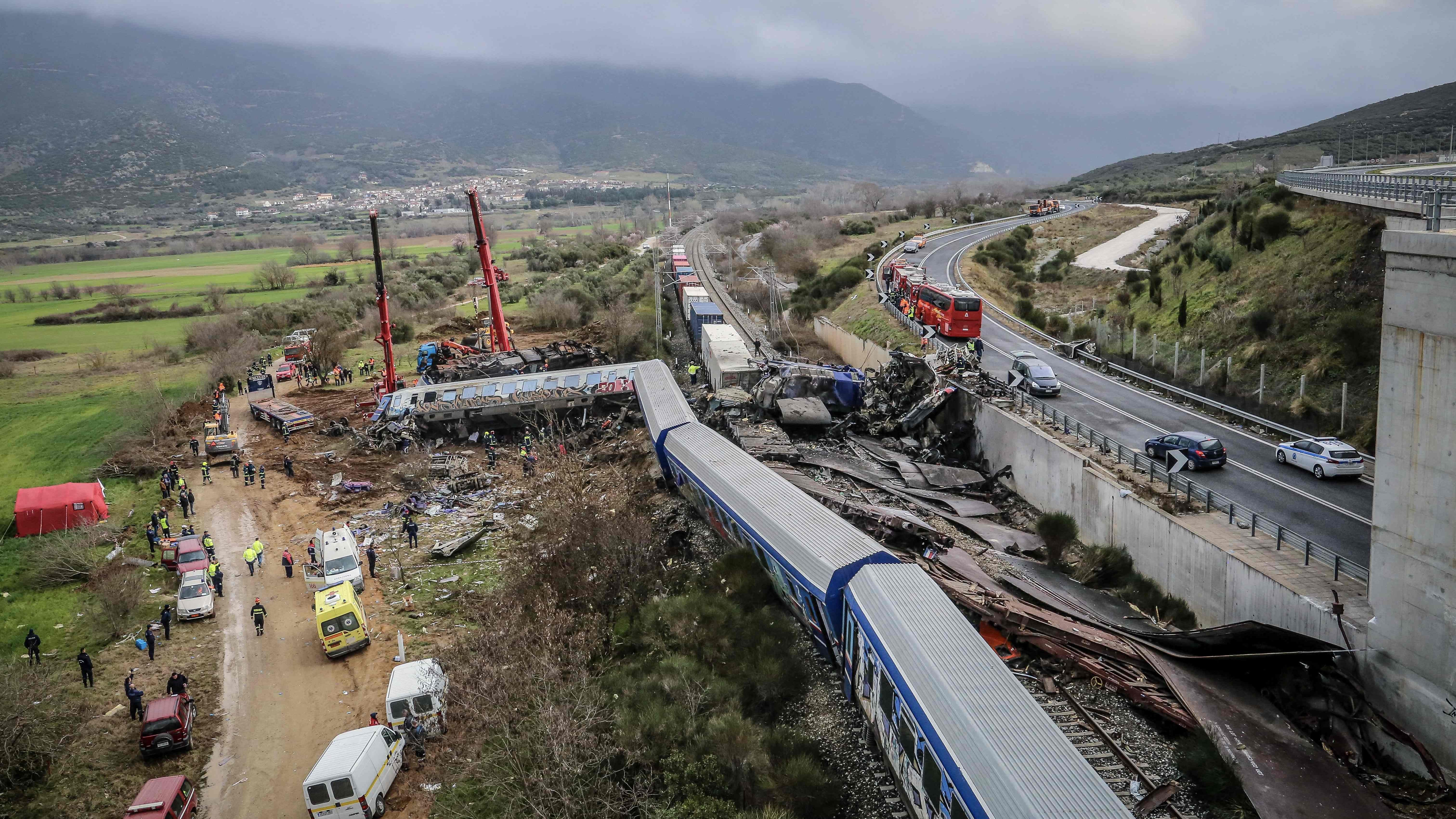 Police and emergency crews search the debris of a crushed wagon after a train accident in the Tempi Valley near Larissa, Greece, March 1, 2023.