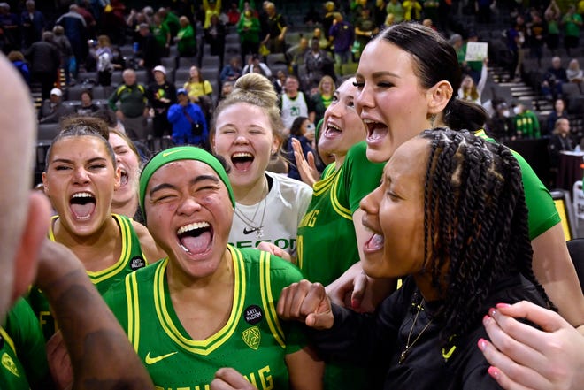 Oregon players celebrate their victory over Washington after the game in the first round of the Pac-12 women's tournament March 1 in Las Vegas.