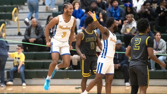 Woodbury's JaBron Solomon, left, celebrates as Woodbury defeated Eagle Academy, 63-56, in the Group 1 boys basketball state semifinal game played at Brick Memorial High School on Wednesday, March 1, 2023.  