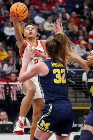 Ohio State guard Taylor Thierry, top, shoots over Michigan forward Leigha Brown (32) in the first half of an NCAA college basketball game at the Big Ten women's tournament Friday, March 3, 2023, in Minneapolis. (AP Photo/Bruce Kluckhohn)