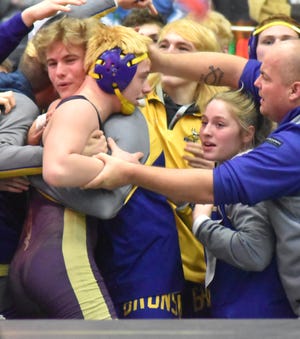 Bronson's Conner Harvey, shown here being mobbed by his teammates and coaches after securing a pin fall to wrap up the D4 semifinal victory versus St. Louis, has been voted as this week's The Daily Reporter Athlete of the Week as sponsored by ProMedica Coldwater Regional Hospital, Omega Physical Therapy and Coldwater Chiropractic and Wellness Center.
