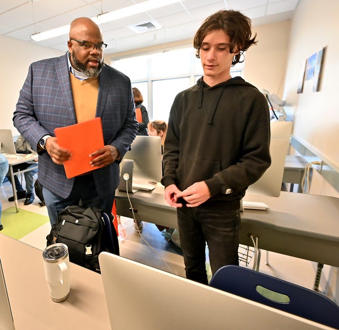 State Secretary of Education Patrick Tutwiler talks with Uxbridge High eighth grader Gavin Scardino in a graphic design class during his visit to the school Friday.