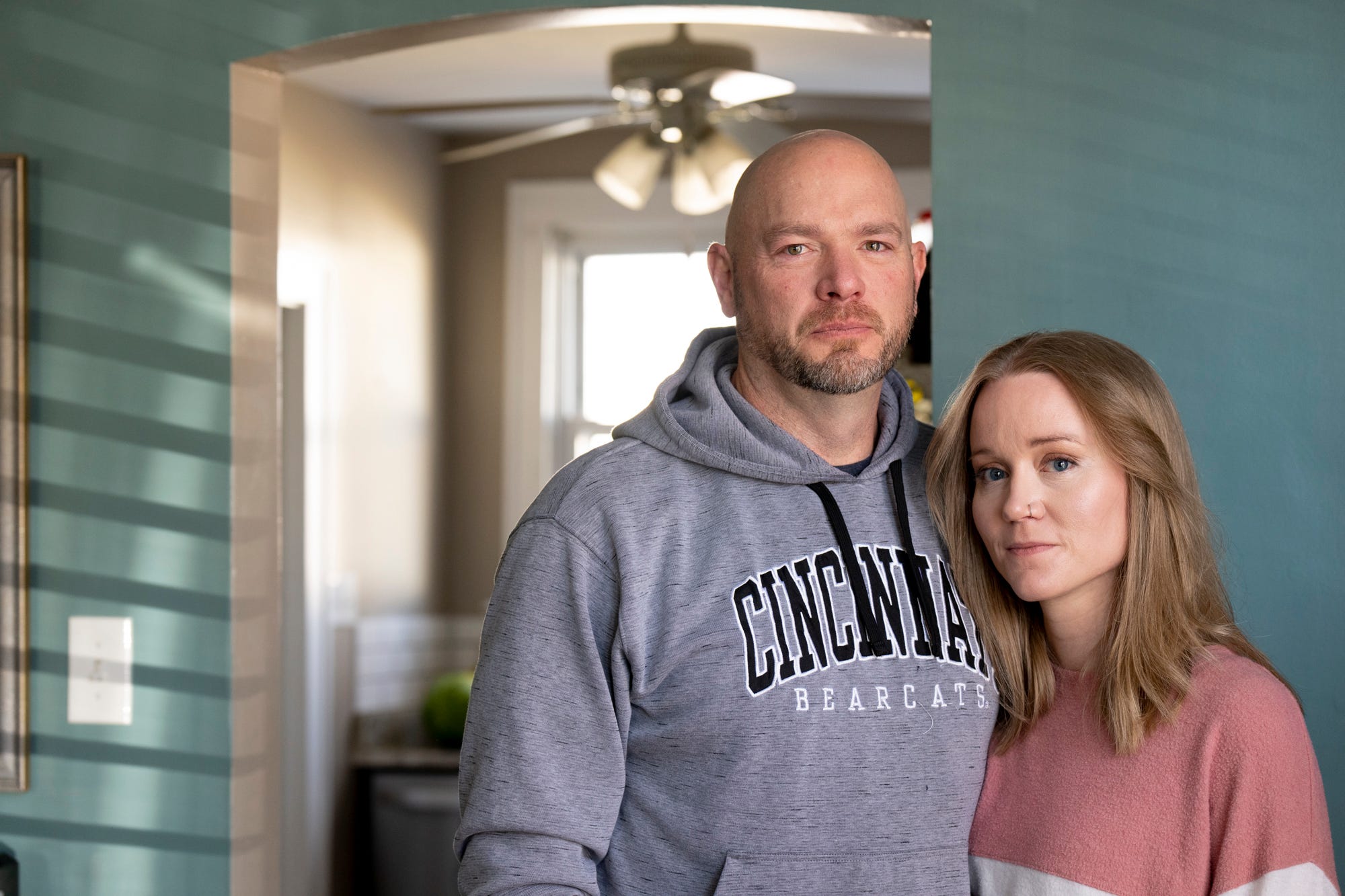 Paul Neyer and his wife, Liesl, stand inside their home on Sunday, Feb. 12, 2023. Paul Neyer decided to come forward with abuse allegations against Father Geoff Drew almost 30 years after he was abused. 