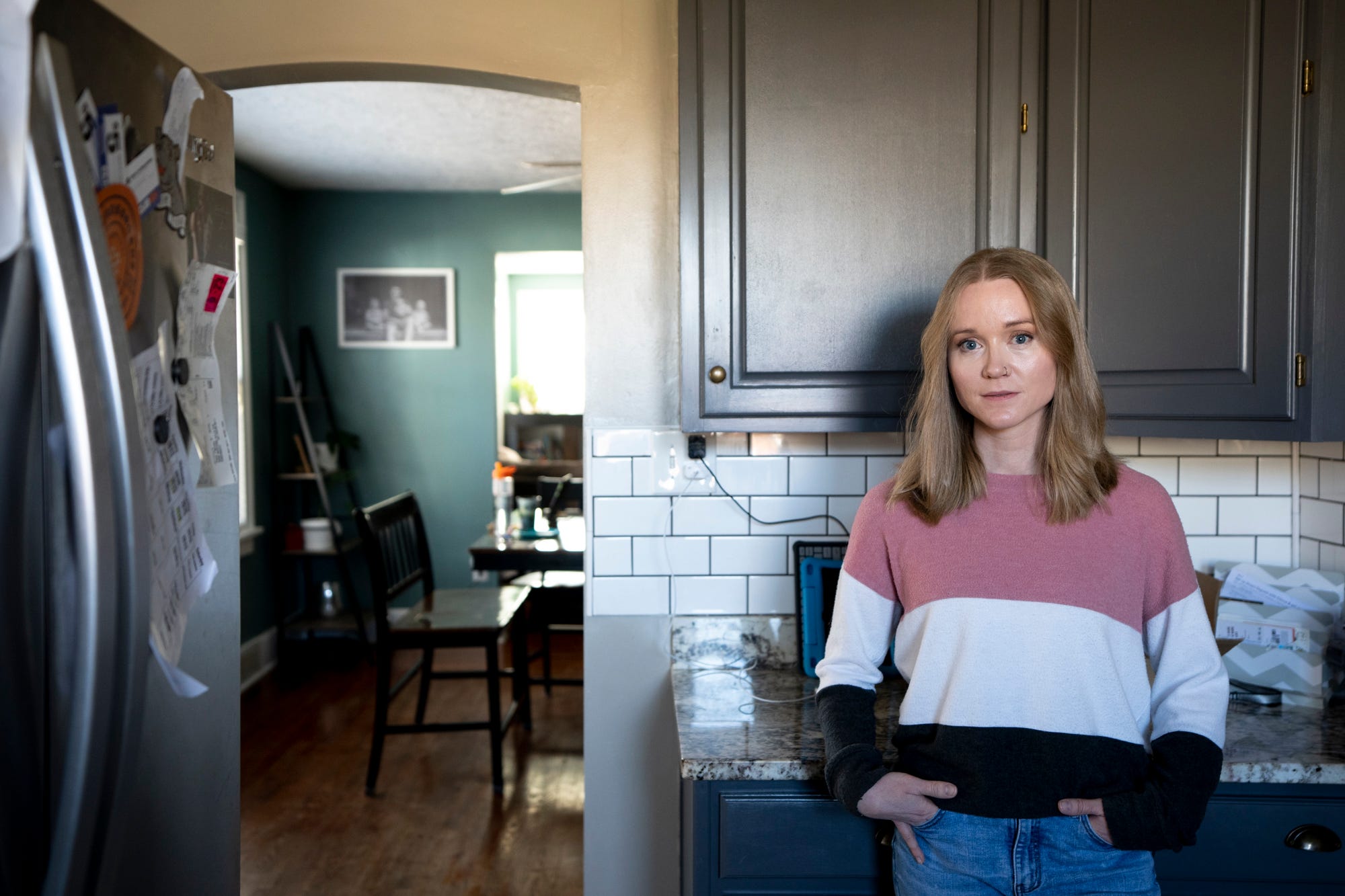 Liesl Neyer stands inside her home on Sunday, Feb. 12, 2023. Liesl’s husband, Paul, decided to come forward with abuse allegations against Father Geoff Drew almost 30 years after he was abused. 