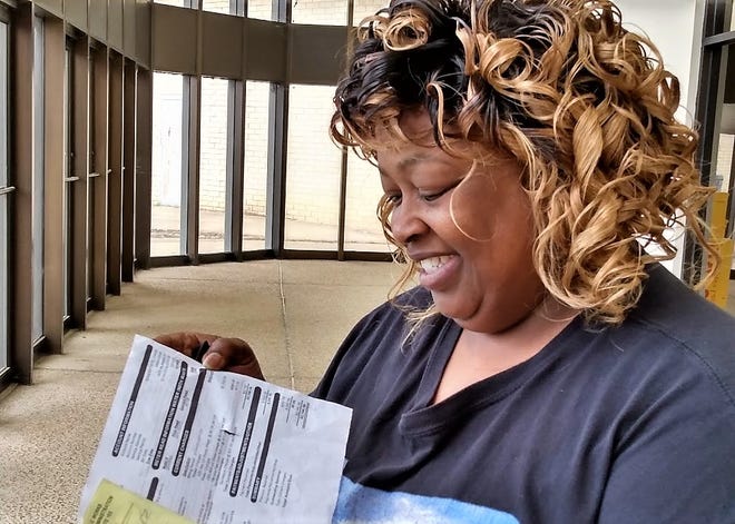Jackson water customer Sandra Jones holds her latest water bill that she said rose from an average of $68 monthly last year to $2166 for the month of February.