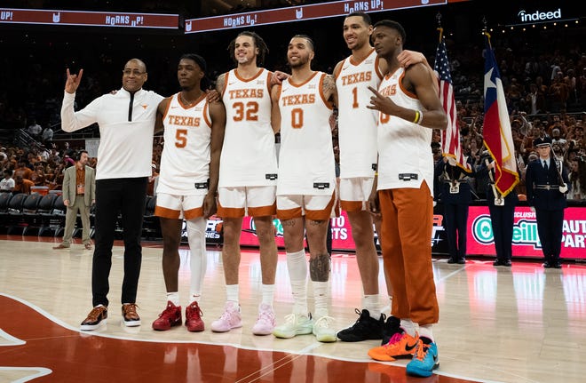Texas interim basketball coach Rodney Terry, left, stands with seniors, from left, Marcus Carr, Christian Bishop, Timmy Allen, Dylan Disu and Jabari Rice during a senior celebration ahead of the Longhorns' win over Kansas on Saturday at Moody Center. The Longhorns enter the Big 12 Tournament as the conference's No. 2 seed, and they hope a deep run in Kansas City could keep their faint hopes for a No. 1 NCAA seed alive.