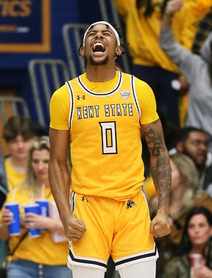 Kent State's Julius Rollins celebrates hitting a three point shot against Akron during their game at the MAC Center in Kent on Friday. The flashes beat the Zips 89-84 in overtime.