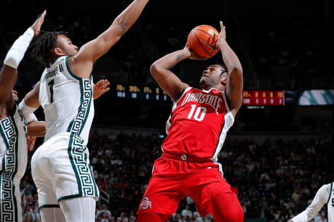 Ohio State's Brice Sensabaugh, right, shoots over Michigan State's Pierre Brooks during the first half of an NCAA college basketball game, Saturday, March 4, 2023, in East Lansing, Mich. (AP Photo/Al Goldis)