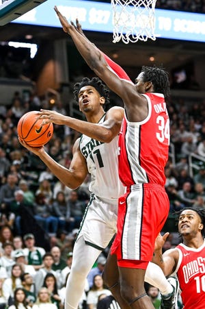 Michigan State's A.J. Hoggard scores as Ohio State's Felix Okpara defends.