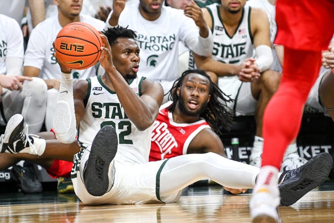 Michigan State's Mady Sissoko looks to pass after diving to the floor for a ball against Ohio State.