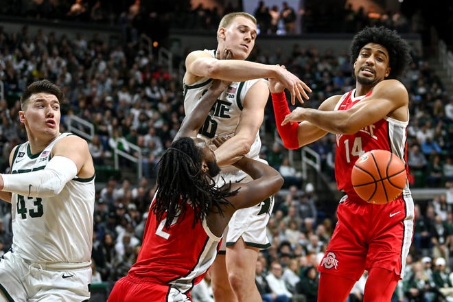 Michigan State's Joey Hauser battles Ohio State's Bruce Thornton, left, and Justice Sueing for a rebound.