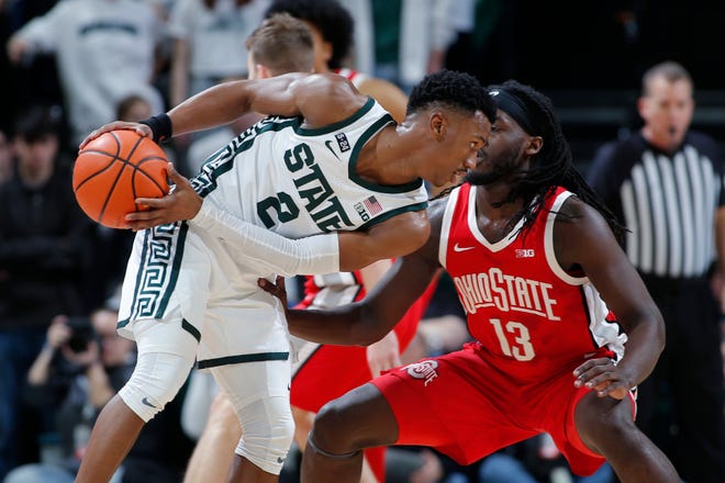 Michigan State's Tyson Walker drives against Ohio State's Isaac Likekele.