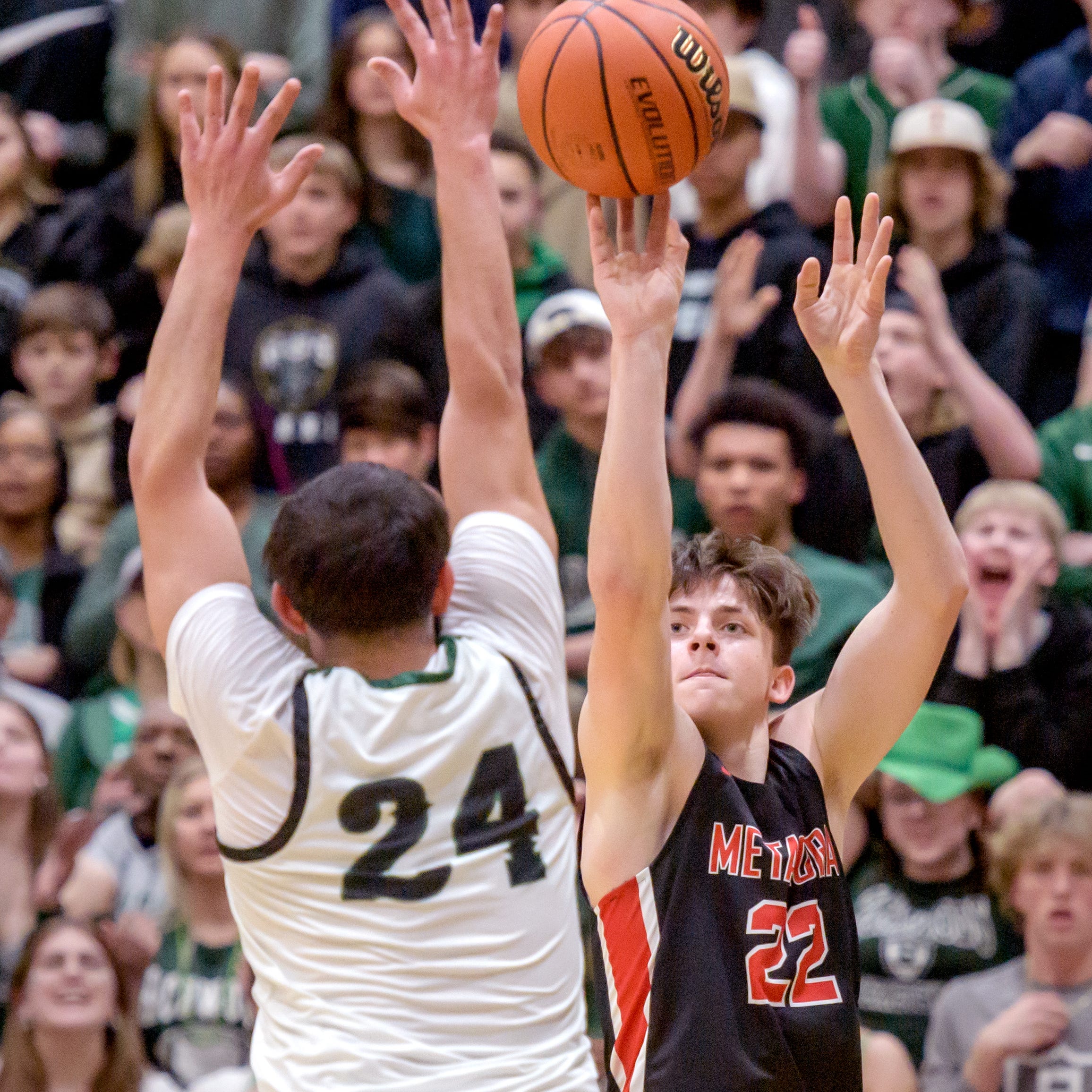 Metamora's Tyson Swanson, right, shoots over Richwoods' Sabri Qattum during their Class 3A sectional final Friday, March 3, 2023 at Galesburg High School. The Redbirds defeated the Knights 65-60.