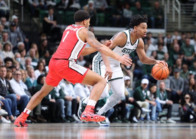Michigan State guard AJ Hoggard catches the ball as he is defended by Ohio State guard Rudy Gayle Jr. during halftime on Saturday, March 4, 2023 at the Breslin Center.