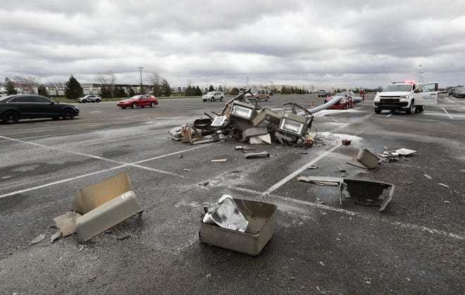 A car was damaged after high winds blew over a light pole in the parking lot at GE Appliance Park in Louisville, Ky. on Mar. 3, 2023.