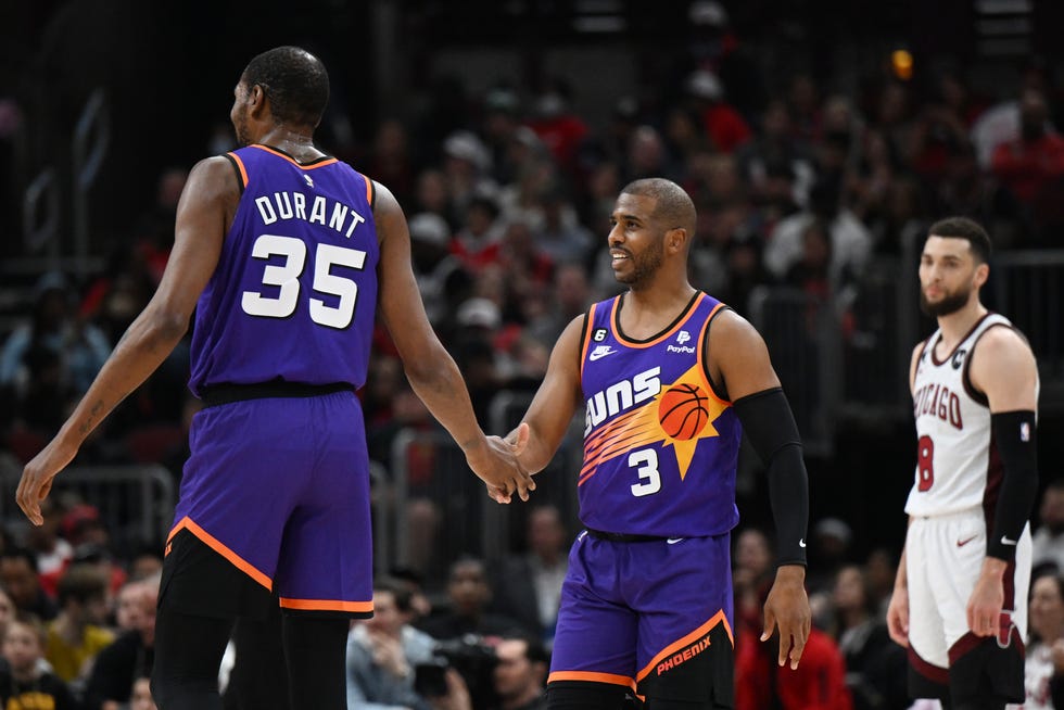Chris Paul (3) and Kevin Durant (35) of the Phoenix Suns celebrate in front of Zach LaVine (8) of the Chicago Bulls in the first half at United Center on March 3, 2023, in Chicago.