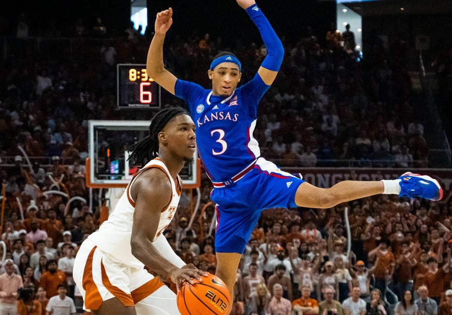 Texas guard Marcus Carr lines up a shot after a fake sent Kansas guard Dajuan Harris Jr. into the air prematurely.