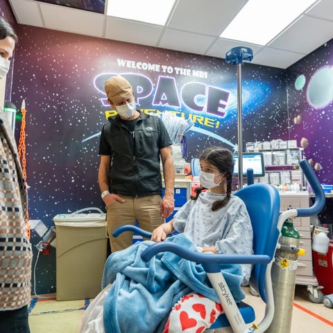 Sabine Barrett, 11, with her parents Ginny and Dan