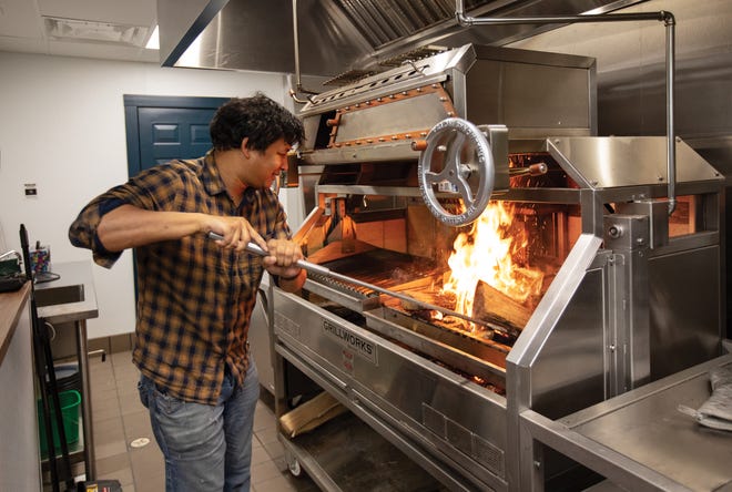 Agni chef-owner Avishar Barua works the fire at his Grillworks grill.