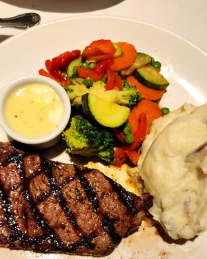 Bistecca alla Mamma at Cassarino's on Federal Hill. The grilled choice grade New York Sirloin comes with a garlic butter sauce. It's served with mashed potatoes and a sautèed vegetable medley.
