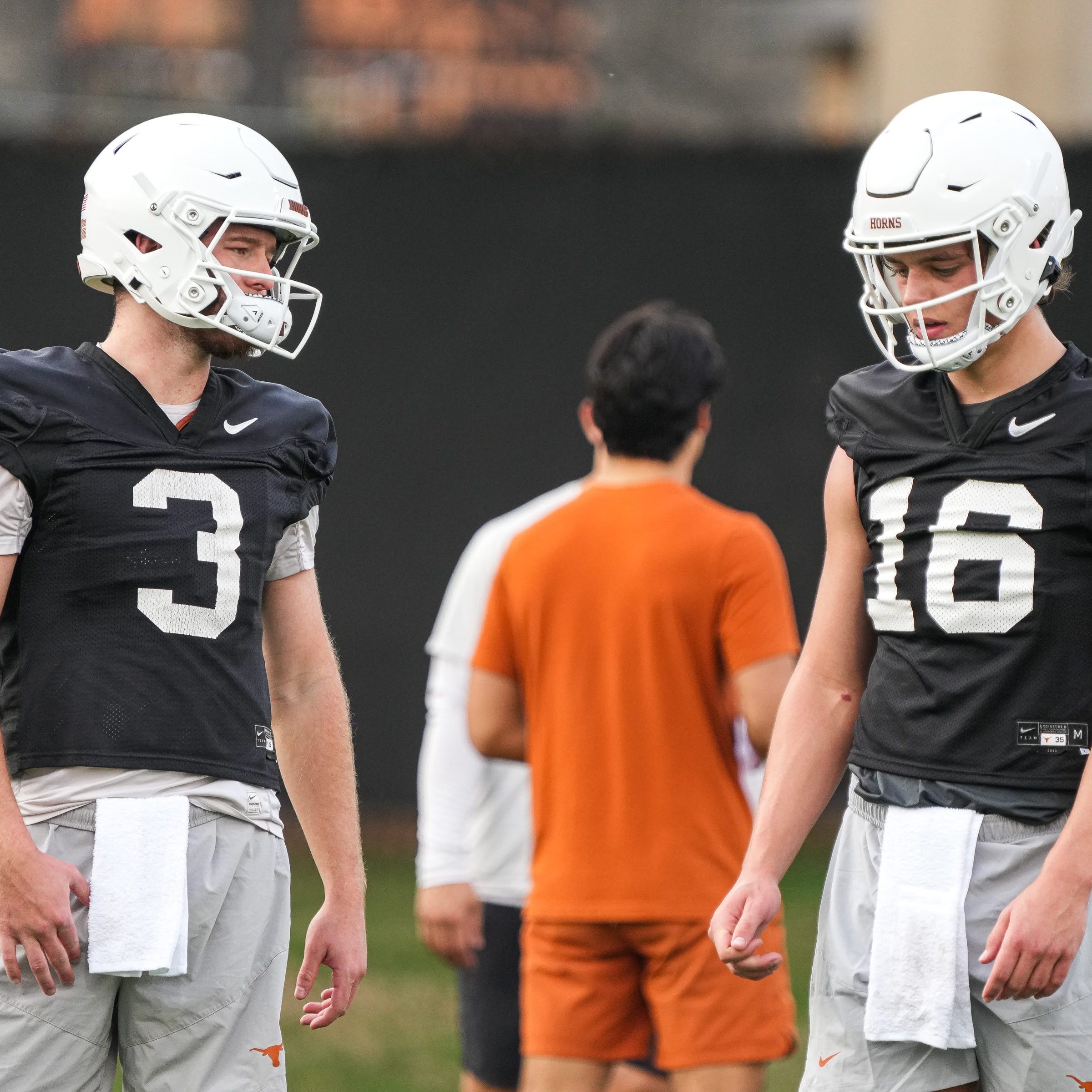 Texas quarterbacks Arch Manning (16) and Quinn Ewers talk during the team's first spring practice of 2023 at the Frank Denius Fields.