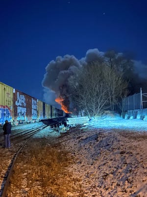 This is what Cami Kridler, Jacob Griffith and their two friends saw Feb. 3 as they headed back to East Palestine after getting food at Wendy's across the state line. This photo is looking west. Part of the 1.7-mile-long train remains upright. In the distance, fire burns where 38 rail cars and tankers overturned.