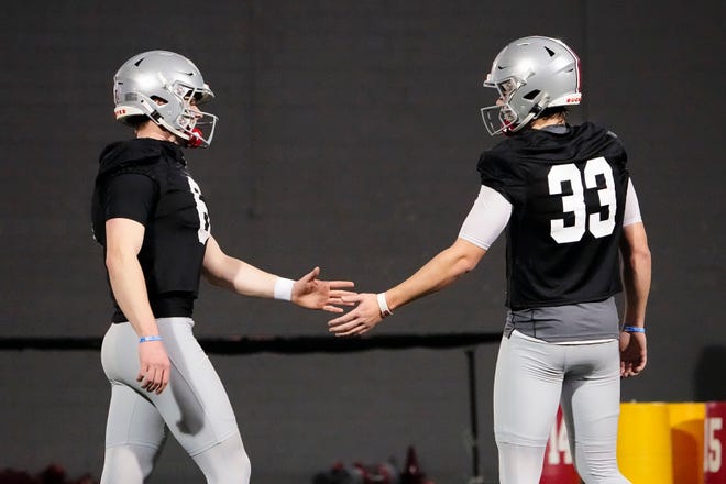 March 7, 2023;  Columbus, Ohio, USA;  Ohio State Buckeyes quarterback Kyle McCord (6) high fives quarterback Devin Brown (33) on day one of spring football drills.  The quarterbacks are both competing for the starting spot.  Mandatory Credit: Adam Cairns-The Columbus Dispatch