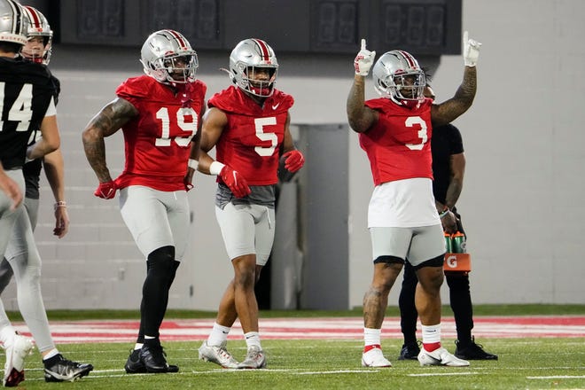 Mar 7, 2023; Columbus, Ohio, USA;  Ohio State Buckeyes running back Miyan Williams (3) dances beside running backs Dallan Hayden (5) and Chip Trayanum (19) during spring football drills at the Woody Hayes Athletic Center. Mandatory Credit: Adam Cairns-The Columbus Dispatch
