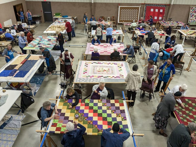 Quilters make quilts for charity during the 2023 Comforter Blitz in Yoder, Kansas.