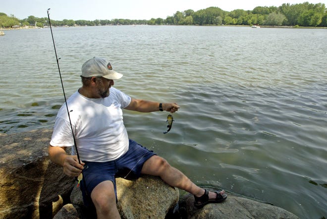 Mike Warner of Sioux City catches a bullhead on Black Hawk Lake in Lake View in 2005.