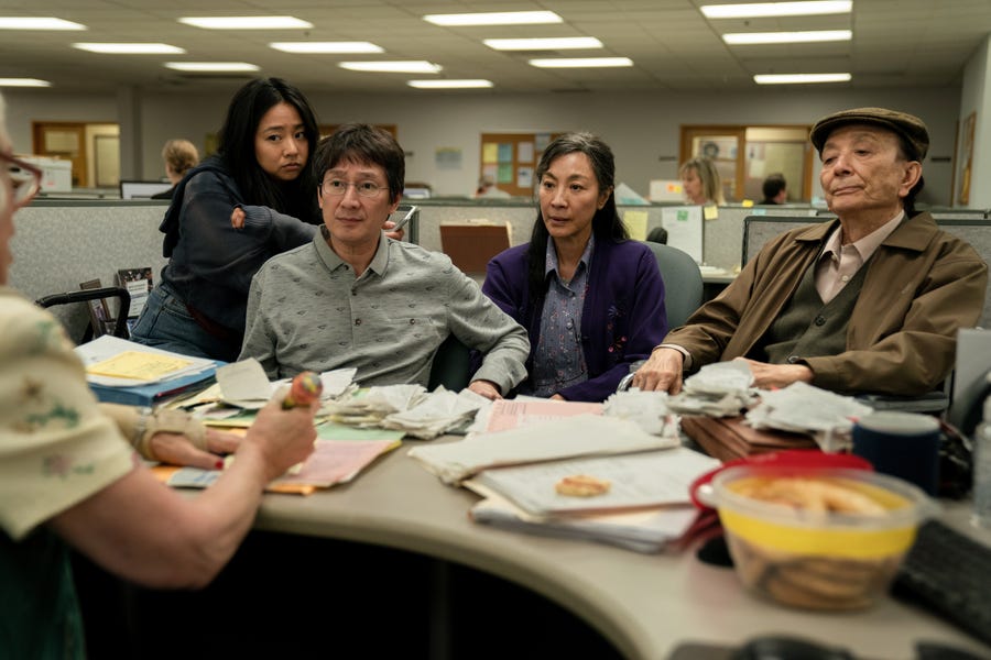 Joy (Stephanie Hsu, left), Waymond (Ke Huy Quan), Evelyn (Michelle Yeoh) and Gong Gong (James Hong) pay a visit to the IRS in "Everything Everywhere All at Once."