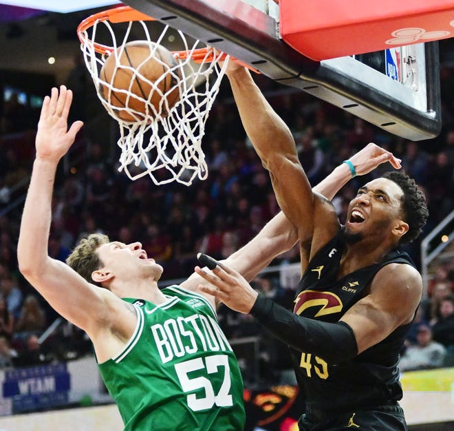 March 6: The Cleveland Cavaliers' Donovan Mitchell (45) dunks over the Boston Celtics' Mike Muscala (57) during overtime at Rocket Mortgage FieldHouse. The Cavaliers won the game, 118-114.