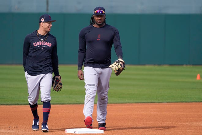 Cleveland Guardians third baseman Tyler Freeman, left, talks with first baseman Josh Bell after batting practice during the first day of spring training in Goodyear, Ariz., Friday, Feb. 17, 2023.