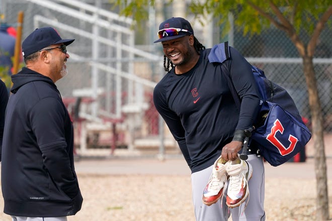 Cleveland Guardians first baseman Josh Bell, right, laughs with assistant hitting coach Victor Rodríguez, as they talk after the first day of spring training in Goodyear, Ariz., Friday, Feb. 17, 2023.