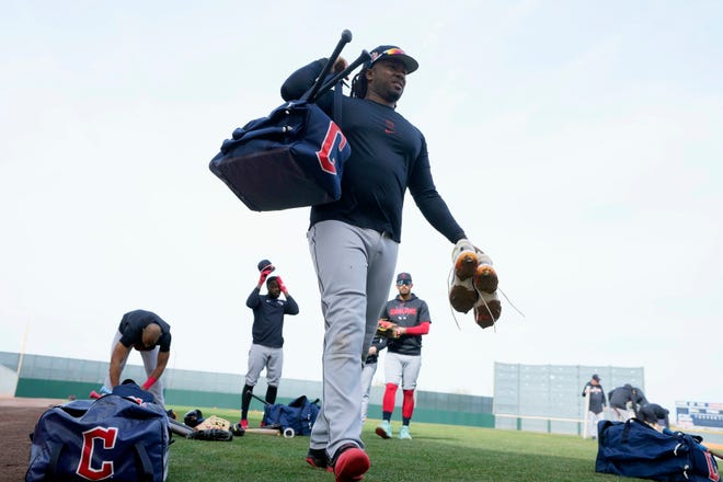 Cleveland Guardians first baseman Josh Bell walks off the field with teammates after batting practice during the first day of spring training in Goodyear, Ariz., Friday, Feb. 17, 2023.